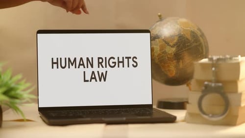 Human Rights Law on Laptop Screen with Handcuffs