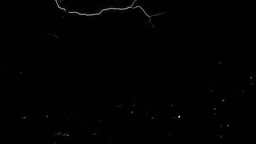 Real flashes of lightning over the city during a powerful thunderstorm.