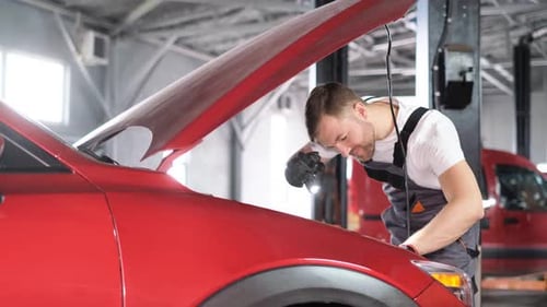 A Technician Checking a Modern Car in a Car Workshop