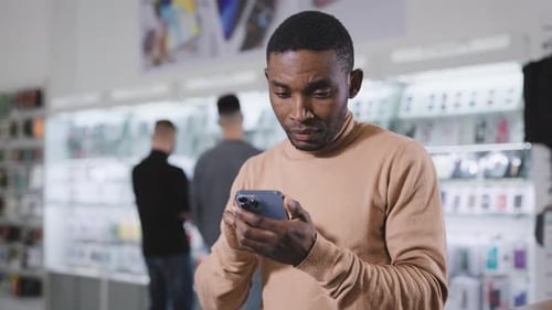 African Man in Electronics and Gadgets Department