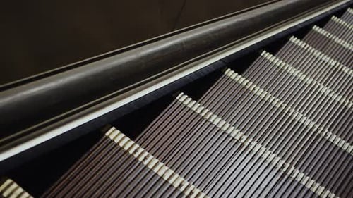 Escalator Moving Down To A Subway Station