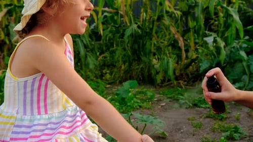 Little Girl Getting Bug Spray Applied Outside