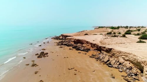 Beautiful Coastal Landscape with Cliffs, Beach, and Calm Ocean Waters