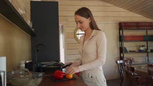 Woman Cutting Vegetables in Kitchen