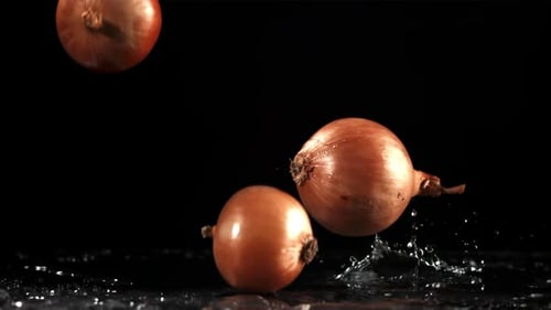 Onion Falls on the Table Filmed is Slow Motion 1000 Fps