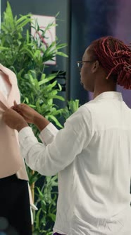Fashion Designer Pins Blazer on Mannequin in Office