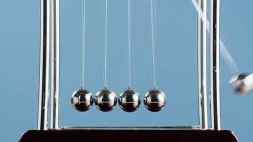 Swinging Newton's Cradle Demonstrates Momentum and Physics