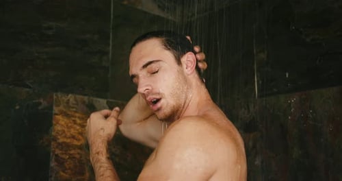 Man Washing Hair in Tiled Shower