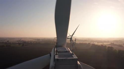 Aerial View of of a Wind Farm During Sunrise in the Countryside Closeup