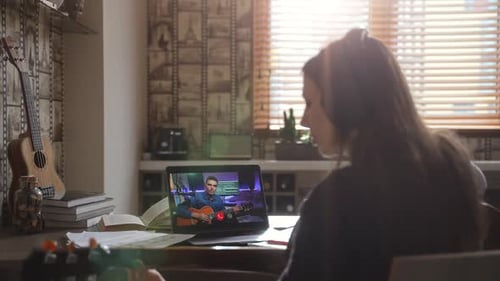 Young Adult Learning Guitar With Online Lesson At Home