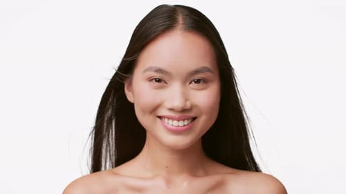 Smiling Woman Poses on a White Background