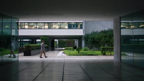Successful businesswoman strolling through downtown district near contemporary office center
