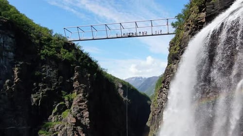 Aerial view of bungee jumper over waterfall, Norway.