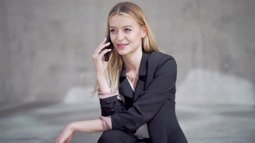 Professional Woman Smiling While Speaking on Phone