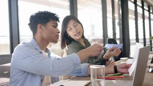 Interior design project, multiracial colleagues using laptop and discussing ideas in office