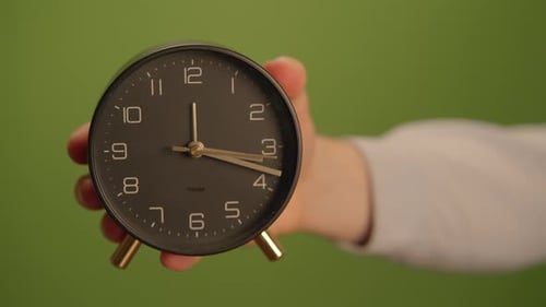 A Stylish Modern Alarm Clock Displayed Against a Fresh Vibrant Green Background Ideal for Any Home
