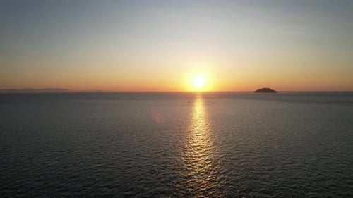 Aerial View of Ocean Sunset with Distant Island
