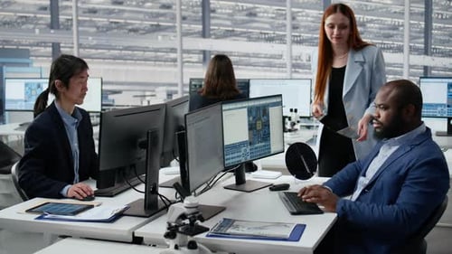 Man and Woman Examining Semiconductor Substrate in Microchip Research Office