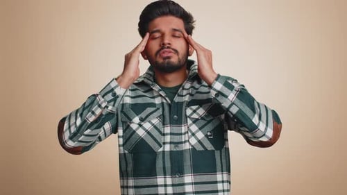 Young Adult Massaging Temples with Headache