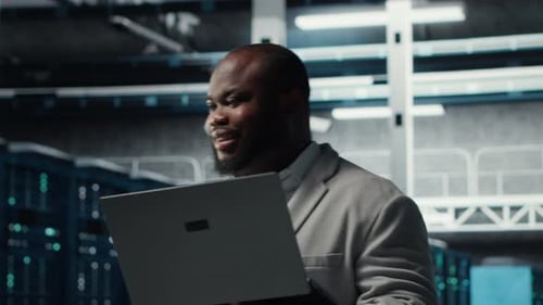 Happy Engineer Walking in Data Center Configuring Storage Devices