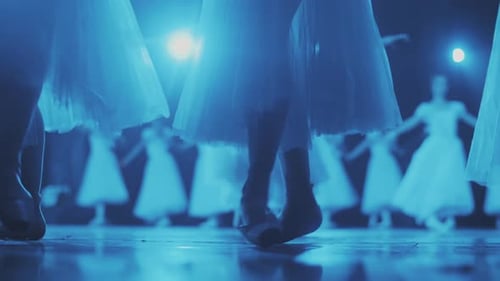 Ballet Dancers Performing Under Blue Stage Lights