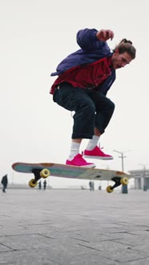 Full Length Rear View of Young Man Skateboarding While Hanging Out at the City Square Outdoors Find