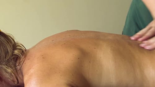 Woman Receives Relaxing Back Massage in Bright Room