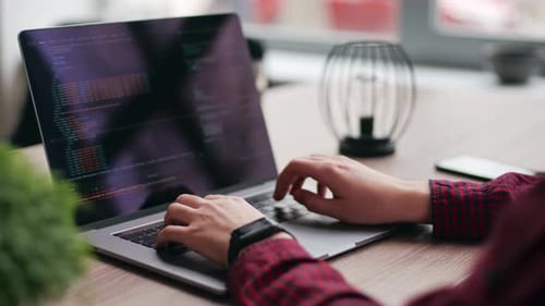 Close Up of Freelancer's Hands Typing Code on Laptop Keyboard Camera Slides Around Developer's