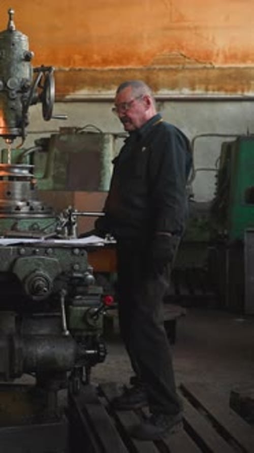 Man Works at Heavy Machine in Factory