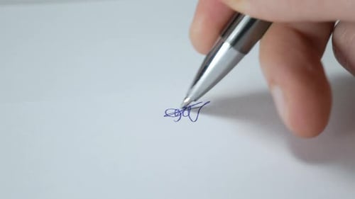 Signing Document with Pen Close Up