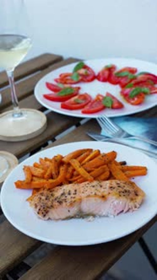 Salmon, Wine and Tomato Salad Dinner Outdoors on Cozy Urban Balcony