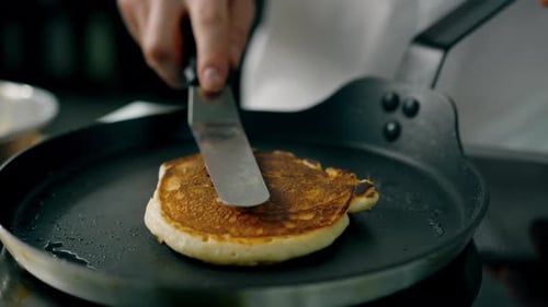 Pancake Cooking on a Griddle in Kitchen