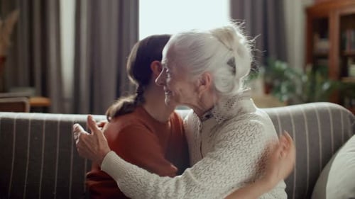 Affectionate Senior Woman and Adult Connecting Indoors