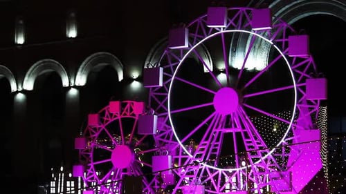 Colorful Ferris Wheel Replicas Spinning At The Park At Night. close up
