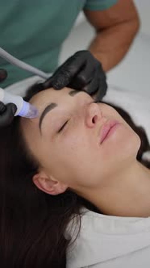 Woman Receiving Facial Cosmetic Procedure in Clinic