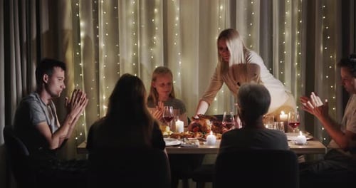 Woman Serving a Turkey to the Festive Table