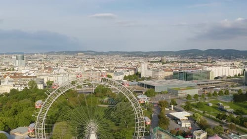 Drone Descends to Reveal Viennese Giant Ferris Wheel in Vienna, Austria on Beautiful Summer Day
