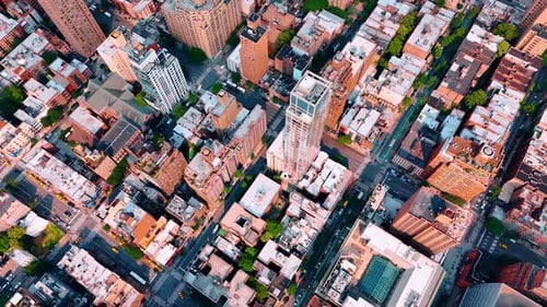 Flight above the blocks and roads in modern city. Sunny scenery of New York, USA from drone.