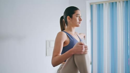 Woman in Workout Clothes Doing Stretching Exercises Indoors