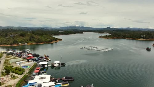 Aerial view rising over a marina at the Peñol-Guatapé Reservoir in Colombia