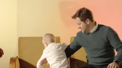 Father Bonding with Infant Son Indoors