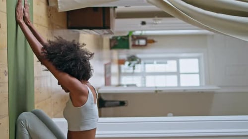 Woman Stretching on Yoga Mat in Sunny Room