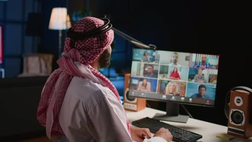 Adult Attends Online Video Conference from Home Office