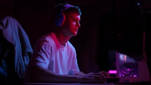 Man Gaming, Typing on Keyboard at Night