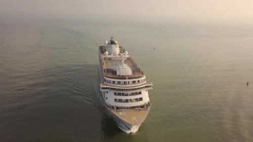 Large cruise ship at sea - Aerial footage at sunrise.