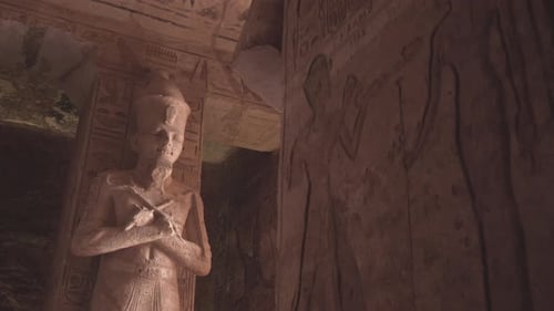 Osiris statue and hieroglyphics in the entrance of Abu Simbel temple.
