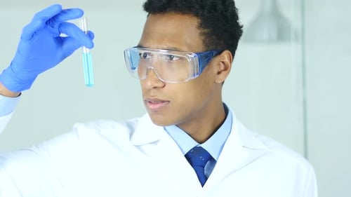 Scientist Inspecting Blue Liquid in Test Tube