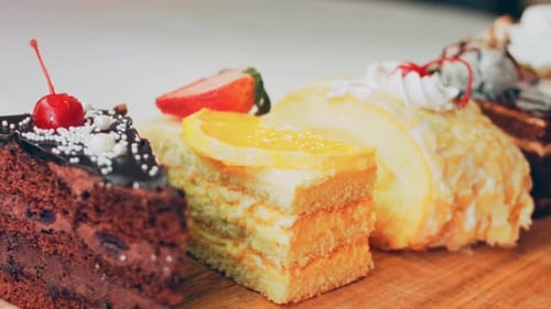 Assorted Cake Slices on Wooden Board