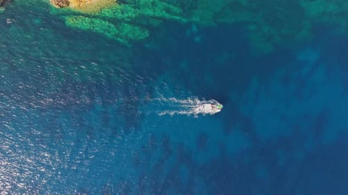 Aerial view of boat sailing on blue water