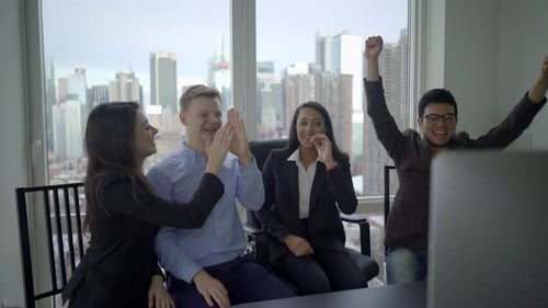 Excited Team Celebrates Success in Modern Office